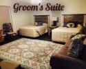Our Groom's Suites has plenty of space along with two full beds and a lovely seating area! 
