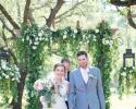 These two love birds just tied the knot beneath a stunning green archway! 